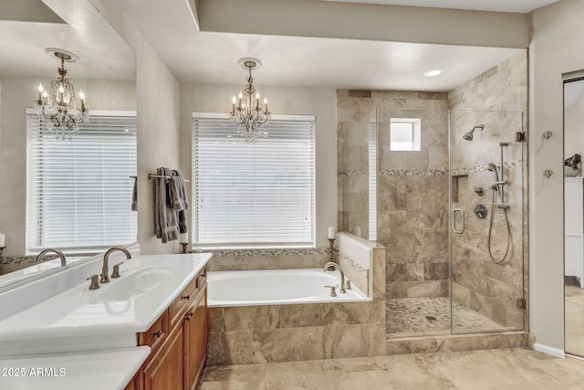 full bath with a garden tub, a shower stall, vanity, and an inviting chandelier