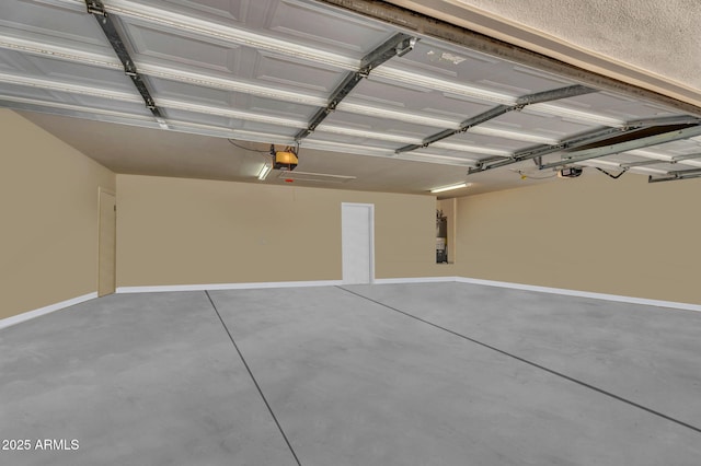 garage with baseboards and a garage door opener