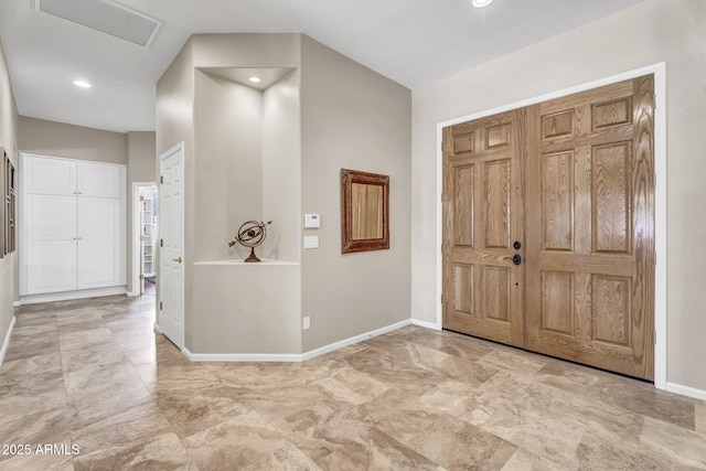 foyer featuring recessed lighting and baseboards