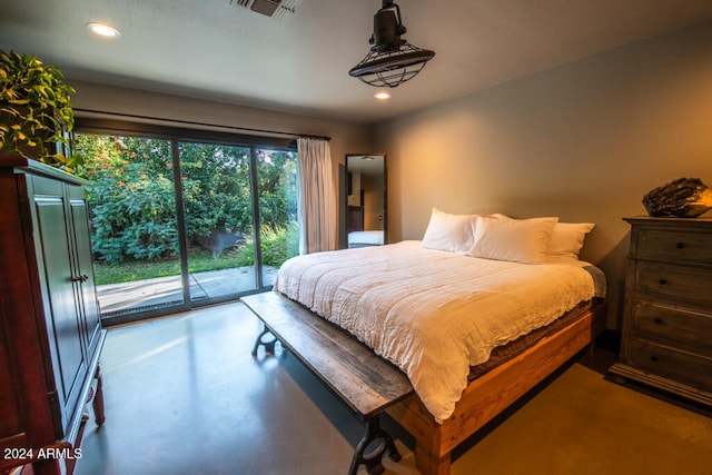 bedroom featuring concrete flooring and access to exterior