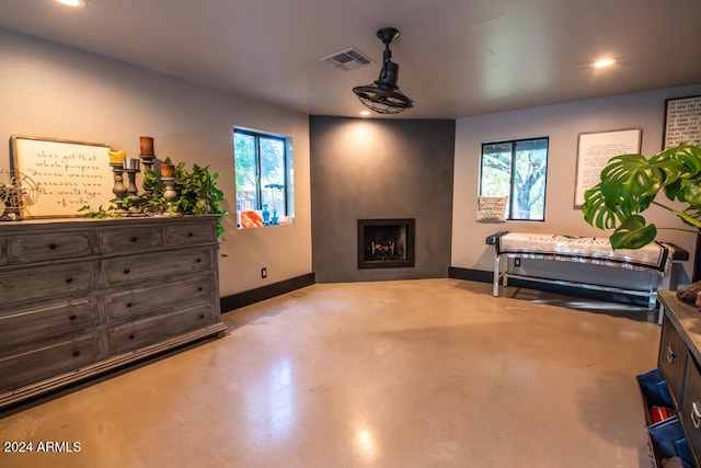 bedroom featuring multiple windows and a fireplace