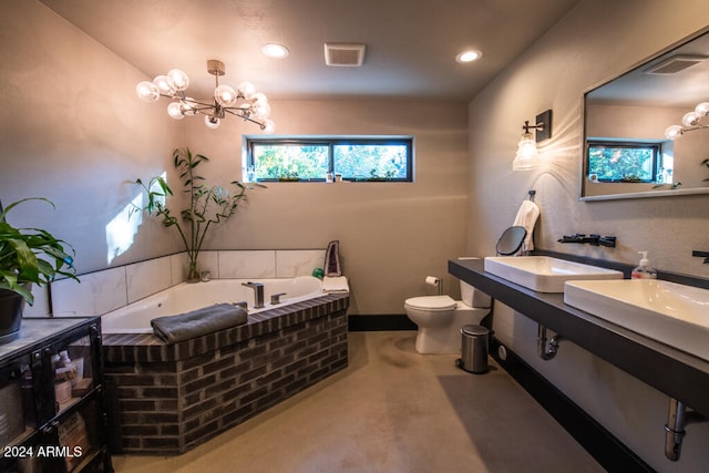 bathroom featuring vanity, a notable chandelier, toilet, and a bath