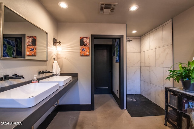 bathroom featuring vanity, a shower, and concrete floors