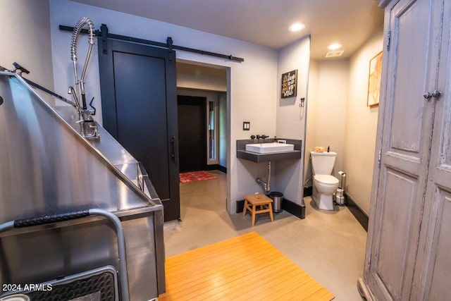 bathroom with toilet, wood-type flooring, and sink