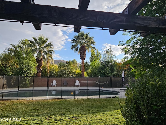 exterior space with a yard and a fenced in pool