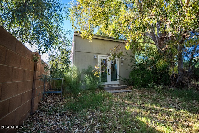 rear view of house featuring french doors