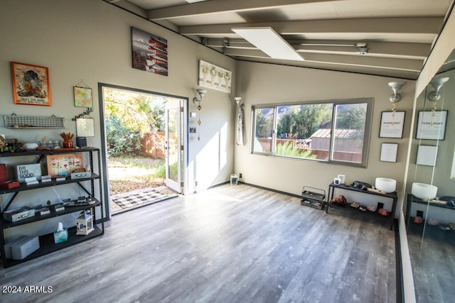 interior space with beam ceiling and hardwood / wood-style flooring