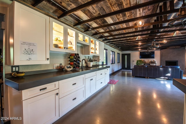 kitchen featuring white cabinetry and sink