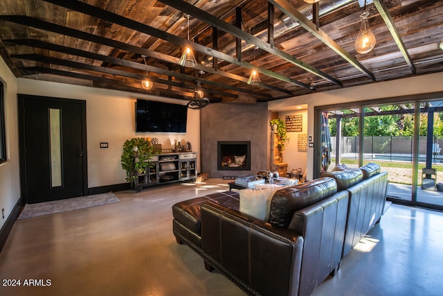 living room with a large fireplace, wood ceiling, and concrete floors