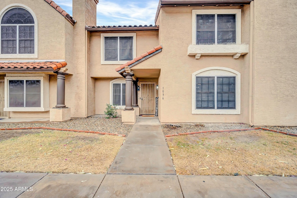 view of front of property featuring a tile roof and stucco siding