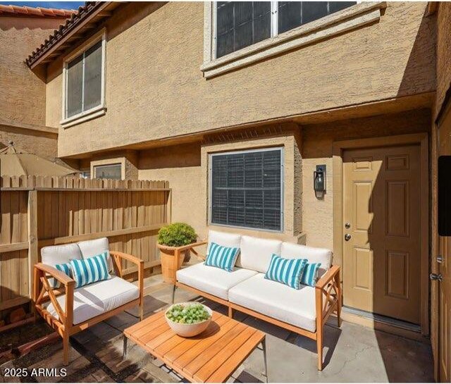 exterior space featuring fence and an outdoor living space