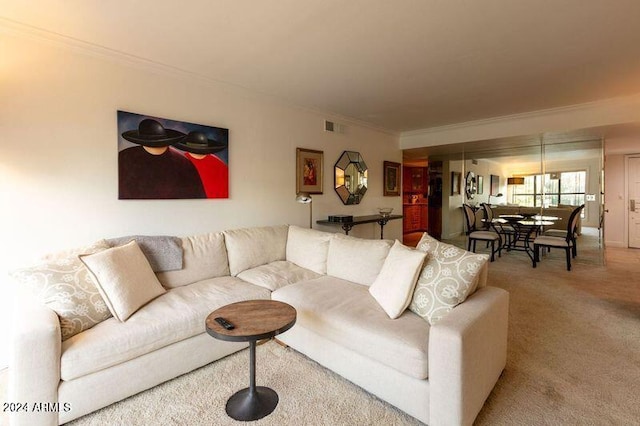 living room with ornamental molding and carpet