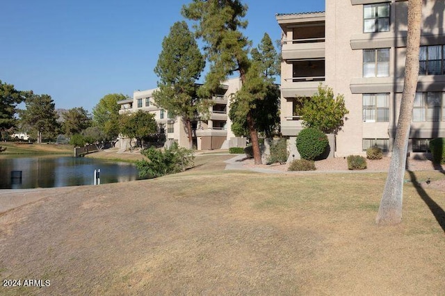 exterior space with a water view and a yard