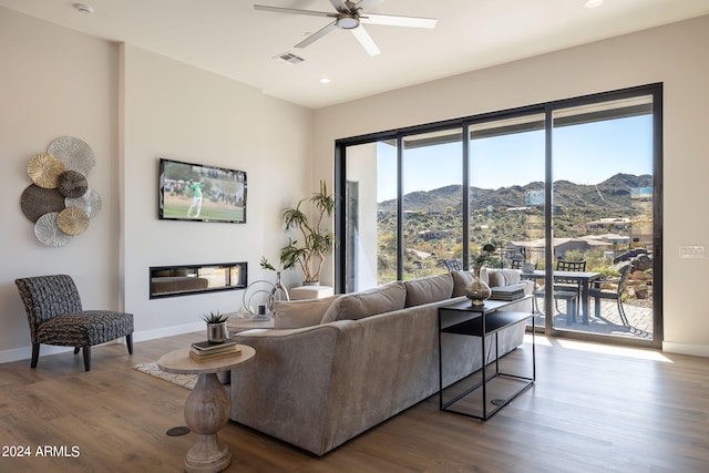 living room with wood-type flooring and ceiling fan