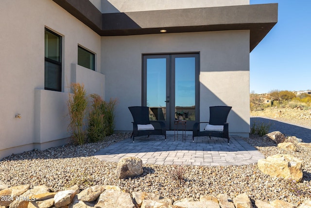 rear view of property featuring a patio area and french doors