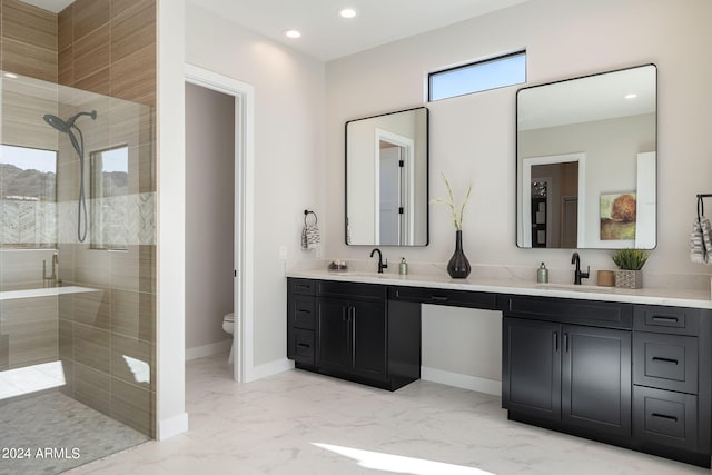 bathroom featuring vanity, toilet, and an enclosed shower