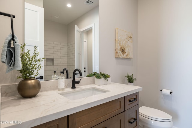 bathroom with vanity and toilet