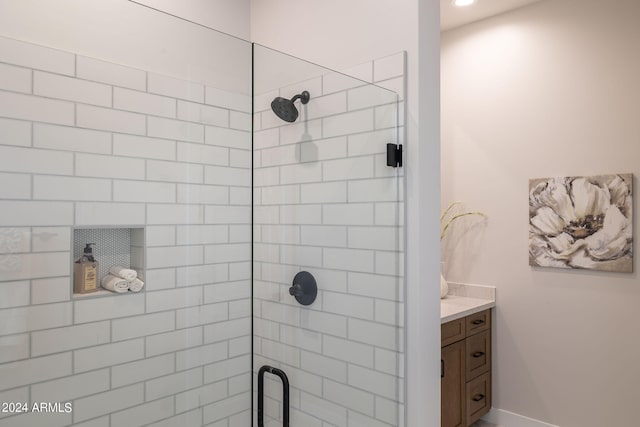 bathroom featuring vanity and an enclosed shower