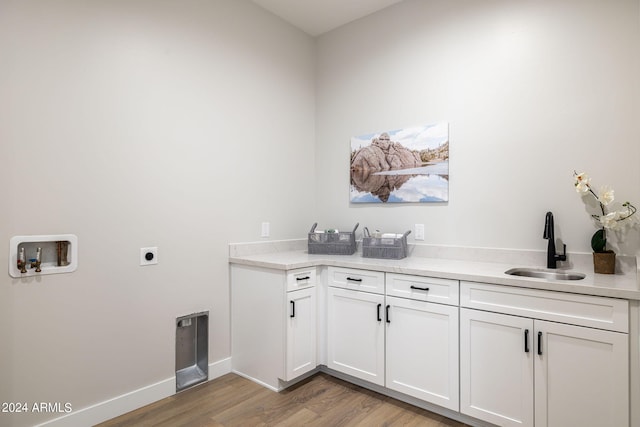 laundry area with cabinets, sink, hookup for a washing machine, hookup for an electric dryer, and wood-type flooring