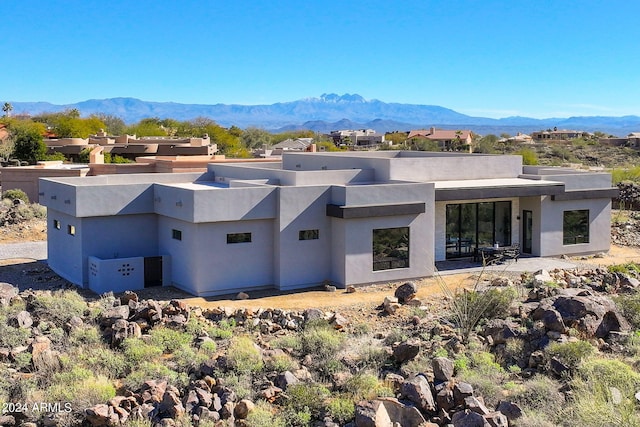 back of house with a mountain view