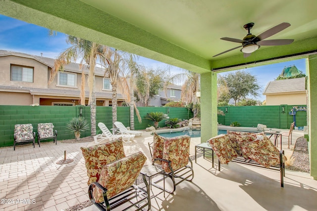 view of patio / terrace with ceiling fan and a fenced in pool