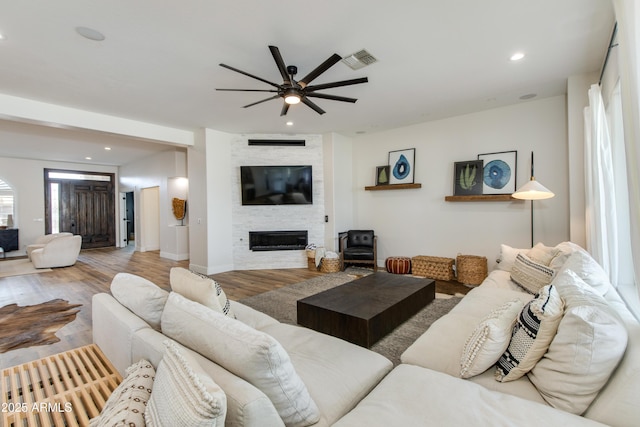 living room with recessed lighting, a fireplace, wood finished floors, a ceiling fan, and visible vents