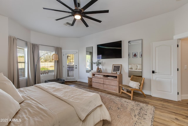 bedroom featuring baseboards, light wood-type flooring, visible vents, and access to exterior