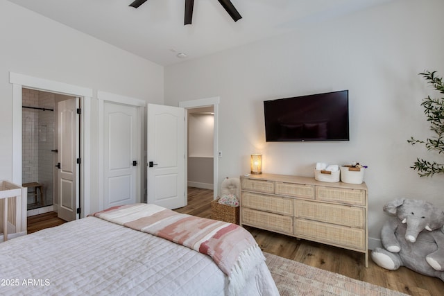 bedroom featuring baseboards, a ceiling fan, dark wood-type flooring, and ensuite bathroom