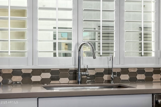 details featuring sink and backsplash