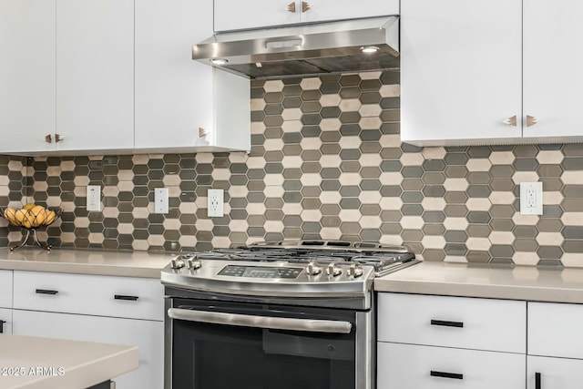 kitchen with white cabinetry, backsplash, range hood, and stainless steel gas stove