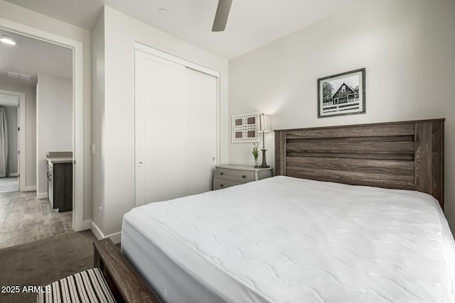 bedroom featuring a closet, ceiling fan, and carpet