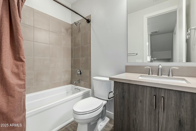 full bathroom with tiled shower / bath combo, vanity, and toilet