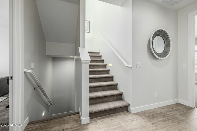 stairs with wood-type flooring