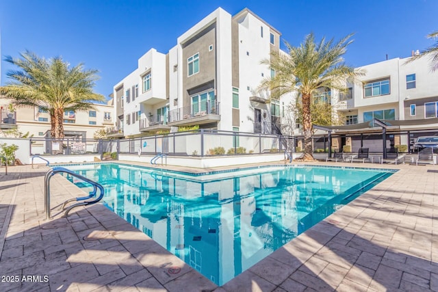 view of pool with grilling area and a patio