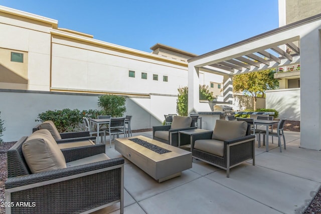 view of patio / terrace with area for grilling, a pergola, and an outdoor living space with a fire pit