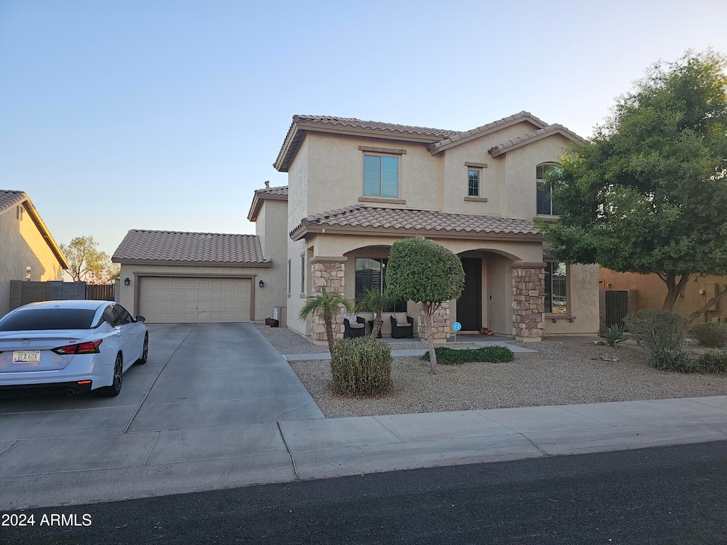 mediterranean / spanish house featuring a garage