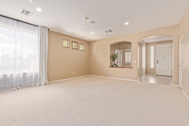 spare room with recessed lighting, visible vents, and light colored carpet