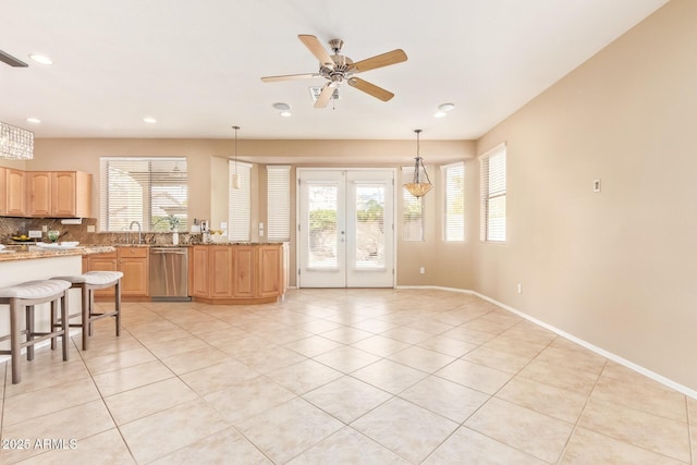 kitchen with light tile patterned floors, ceiling fan, light brown cabinetry, french doors, and dishwasher