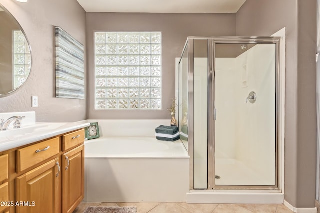 full bath featuring tile patterned flooring, a shower stall, vanity, and a garden tub