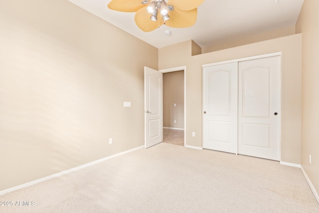 unfurnished bedroom with a closet, baseboards, carpet, and a ceiling fan