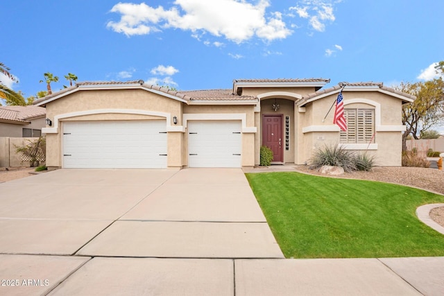 view of front of house with driveway, an attached garage, stucco siding, a front lawn, and a tile roof