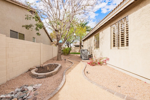 view of yard featuring a fenced backyard and central AC