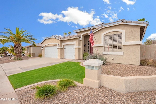 mediterranean / spanish home featuring stucco siding, an attached garage, driveway, and a front lawn