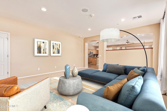 living area featuring a ceiling fan, recessed lighting, visible vents, and arched walkways