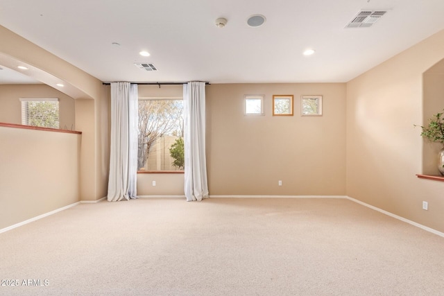 carpeted empty room featuring recessed lighting, visible vents, and baseboards