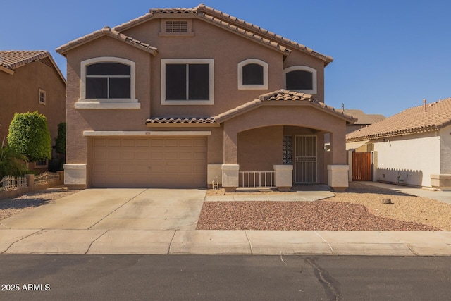12720 W Cantenia Rd, Avondale, AZ 85392 - mediterranean / spanish house featuring a tile roof, stucco siding, an attached garage, concrete driveway, and a porch