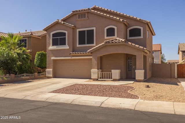 12720 W Cantenia Rd, Avondale, AZ 85392 - mediterranean / spanish-style home with a tile roof, an attached garage, stucco siding, concrete driveway, and a gate