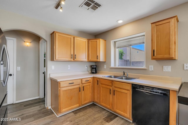 12720 W Cantenia Rd, Avondale, AZ 85392 - kitchen with black dishwasher, arched walkways, light wood-type flooring, and light countertops