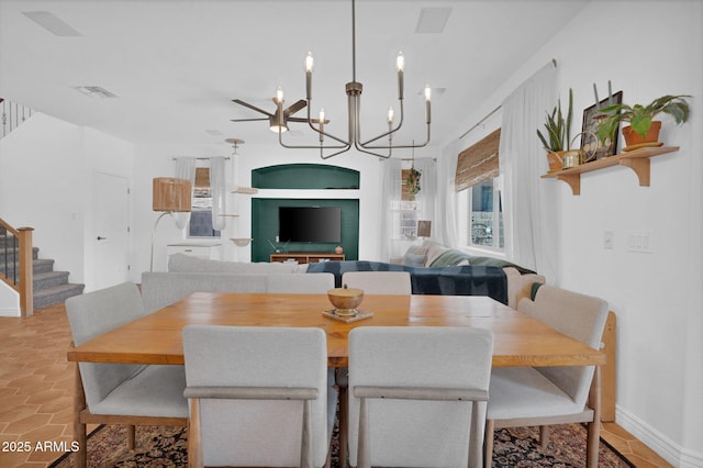 dining space with stairway, baseboards, visible vents, and an inviting chandelier