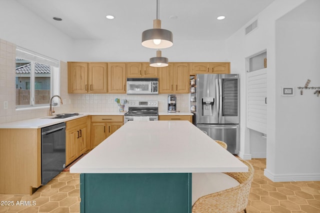 kitchen featuring visible vents, a sink, stainless steel appliances, light countertops, and backsplash